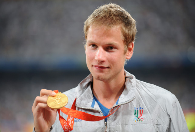 (FILES) Photo taken on August 22, 2008 shows Italy's Alex Schwazer posing with his gold medal on the podium of the men's 50 km walk of the 2008 Beijing Olympic Games. Italy's reigning 50km walk champion Schwazer has been withdrawn from the London 2012 Olympic games for failing a drugs test, a source with knowledge of the case confirmed to AFP on August 6, 2012. AFP PHOTO / FABRICE COFFRINI (Photo credit should read FABRICE COFFRINI/AFP/GettyImages)